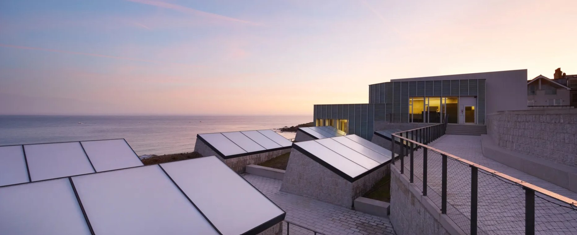 Tate St Ives at dusk: gallery rooflights opening towards the sea